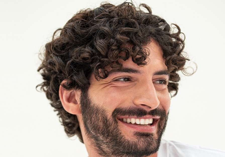 Man with curly hair in a CRLAB campaign photograph